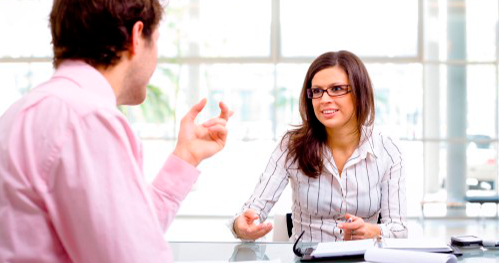 A man and woman are sitting at a table